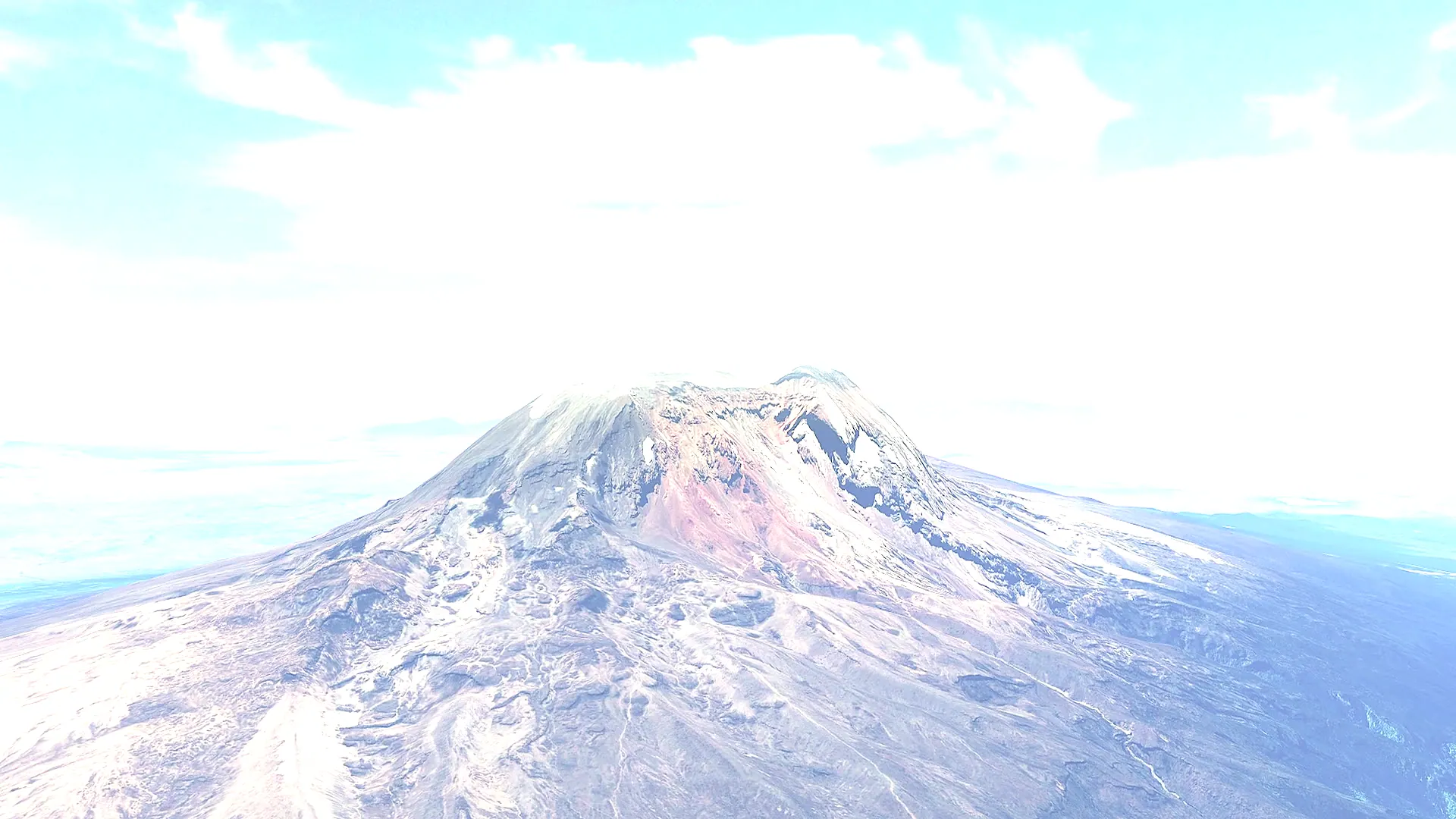 The crater rim and glaciers of Kilimanjaro from the air, the mountain's flanks falling away below