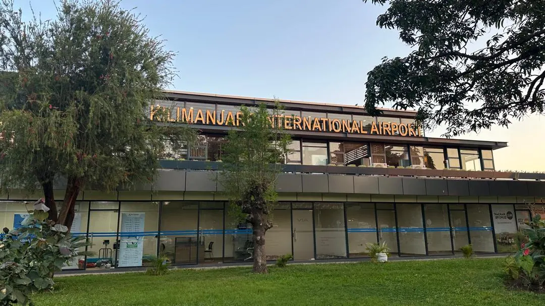 The Kilimanjaro International Airport terminal seen from under the trees of the car park